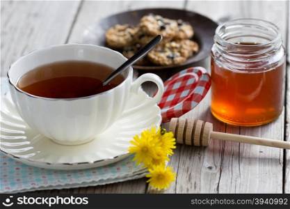 Cup of hot tea with delicious cookies selected