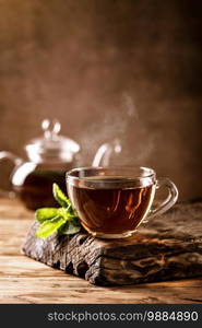 Cup of hot tea with fresh mint leaves