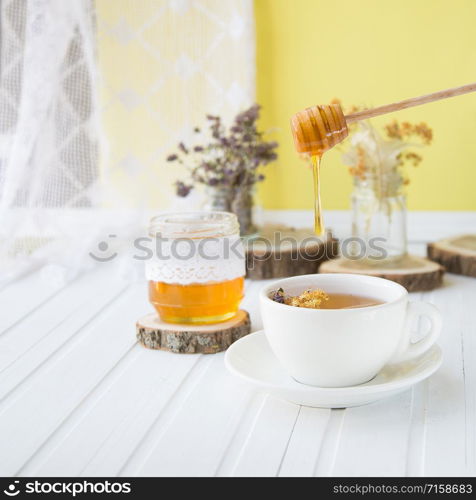 Cup of hot tea with sacking on the wooden table and the tea plantations background. Cup of hot tea with sackingCup of hot tea with sacking on the wooden table