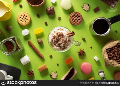 cup of ice cream coffee at green paper background
