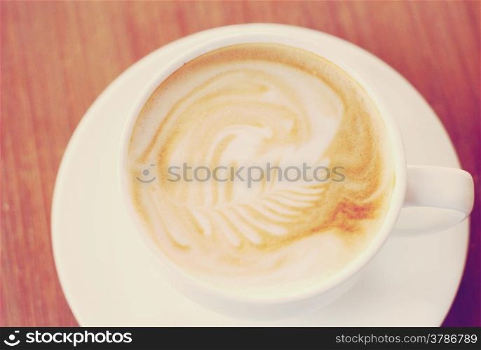 Cup of latte or cappuccino coffee with retro filter effect