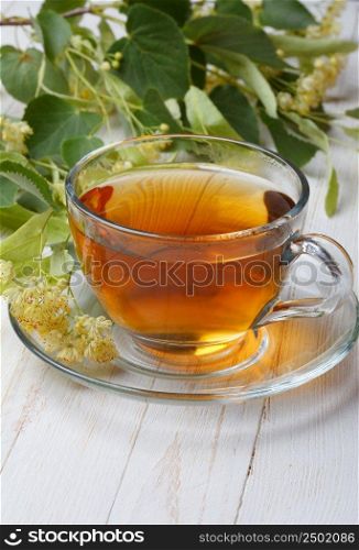 Cup of linden tea on wooden table still life