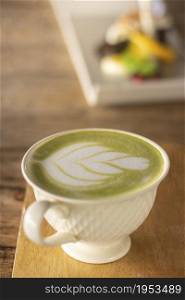 Cup Of Matcha Latte Green Tea On Dark Wooden Background.