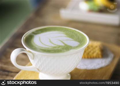Cup Of Matcha Latte Green Tea On Dark Wooden Background.