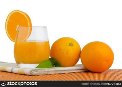 Cup of orange juice and fresh orange as a background