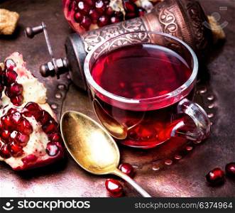 Cup of pomegranate tea. turkish winter tasty tea with pomegranate seeds