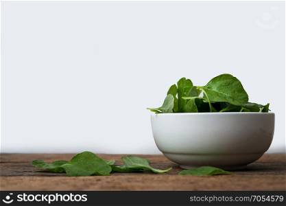 cup of spinach on wooden table