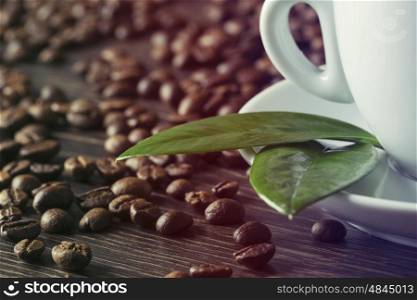 Cup of strong coffee and corn on table. Coffee cup