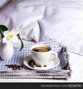 Cup of strong coffee with white flowers on rustic wooden serving tray. Tender love concept.Square. Cup of strong coffee square