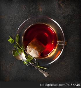 Cup of tea and mint on rustic background