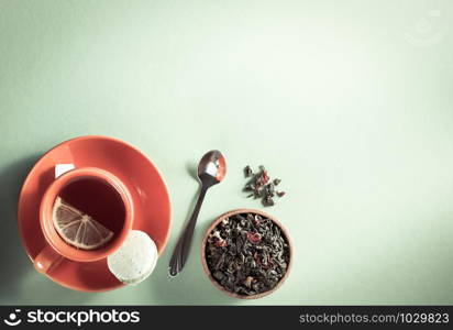 cup of tea at light green paper background