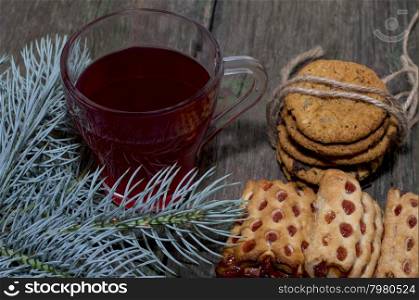 cup of tea, fir-tree branch and two linking of cookies, subject Christmas and New Year