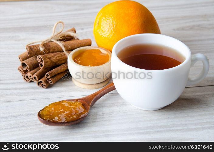 Cup of tea served with orange jam
