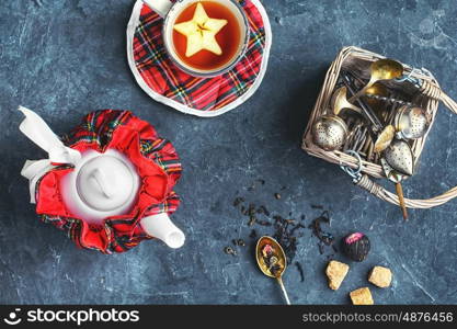 Cup of tea. Set of the stylish kettle and Cup of tea on the slate background