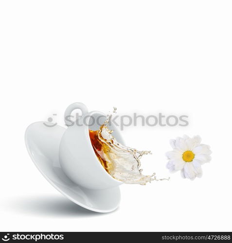 Cup of tea. White cup of chamomile tea against white background