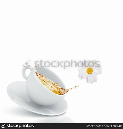 Cup of tea. White cup of chamomile tea against white background