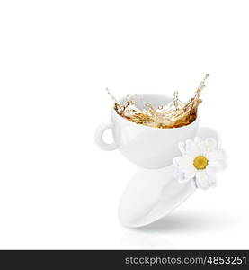 Cup of tea. White cup of chamomile tea against white background