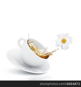 Cup of tea. White cup of chamomile tea against white background