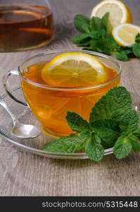 Cup of tea with a slice of lemon, mint