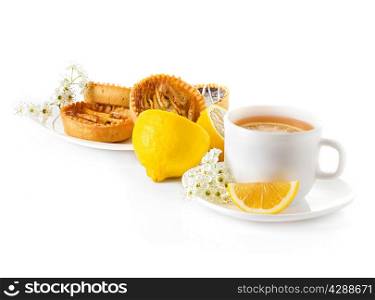 cup of tea with lemon and pastries