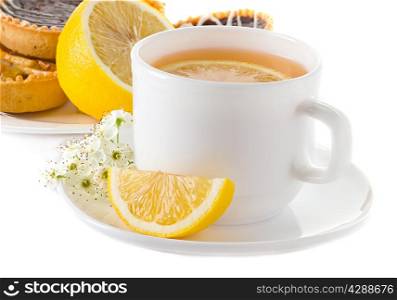cup of tea with lemon and pastries