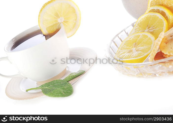 cup of tea with lemon, pastry and sugar