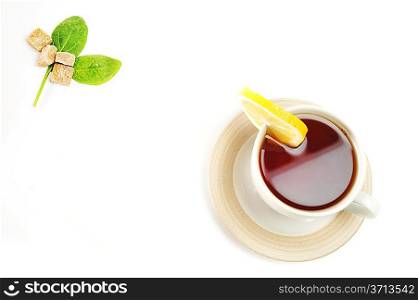 cup of tea with lemon, pastry and sugar