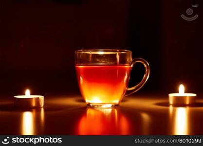 cup of tea with lighting candles
