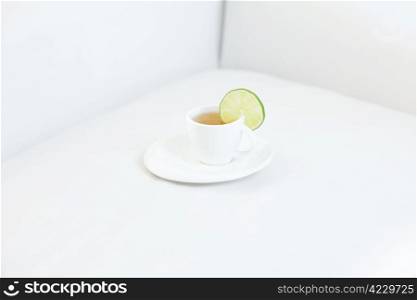 cup of tea with lime on sofa
