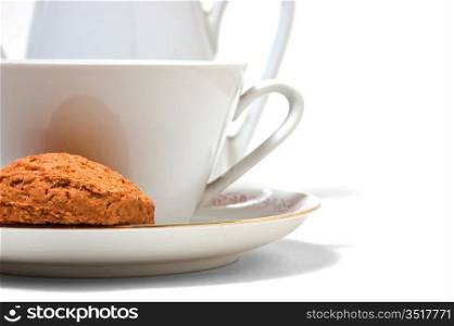 cup on a saucer and biscuits isolated on white