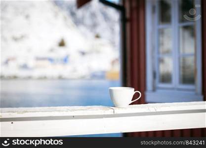 cup on the background of rorbu. Lofoten islands. Norway