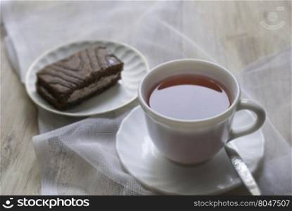 Cup on the table and cake . standing on the table with a Cup of tea and cake