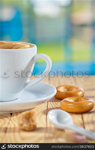 cup spoon sugar and cookie on table