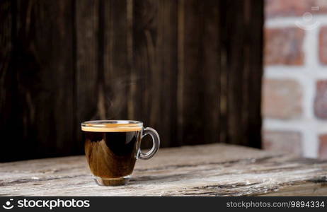 Cup with coffee espresso arranged on a dark wooden background. Close up, selective focus, copy space