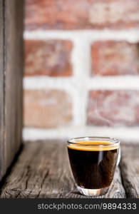 Cup with coffee espresso arranged on a old bricks background. Close up, selective focus, copy space, minimalism