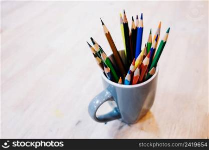 cup with colored pencils