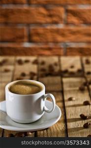 cup with espresso on the wooden boards