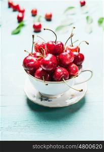 Cup with fresh ripe cherry berries, front view, close up