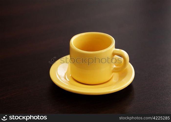 cup with saucer on a wooden table