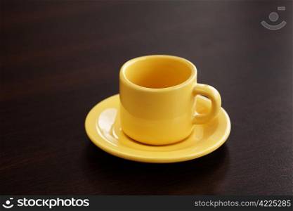 cup with saucer on a wooden table