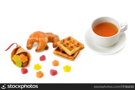 Cup with tea and delicious pastries isolated on a white background. Flat lay,top view.