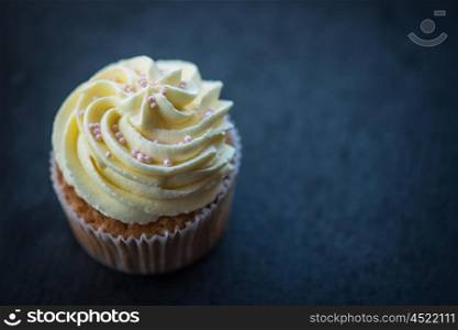 Cupcake desert cream. Cupcake desert cream with space for text on a stone background