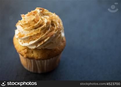 Cupcake desert cream. Cupcake desert cream with space for text on a stone background