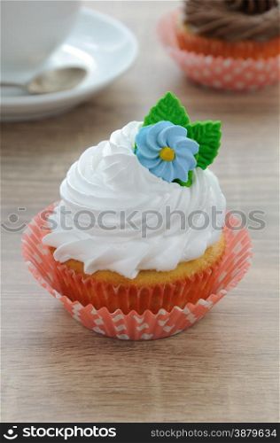 Cupcake with butter cream decorated with marzipan flower