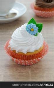 Cupcake with butter cream decorated with marzipan flower