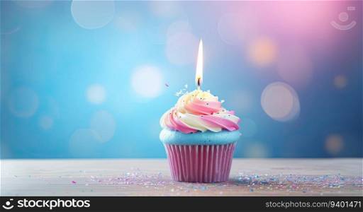 Cupcake with candle on blue bokeh background. Birthday concept