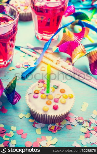 Cupcake with candle over party decor background. Happy birthday greeting card, horizontal
