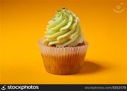 cupcake with cream isolated on orange background