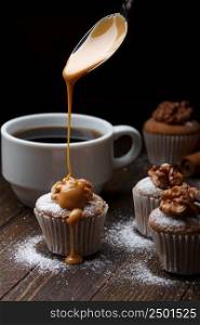 Cupcake with nuts and flowing caramel