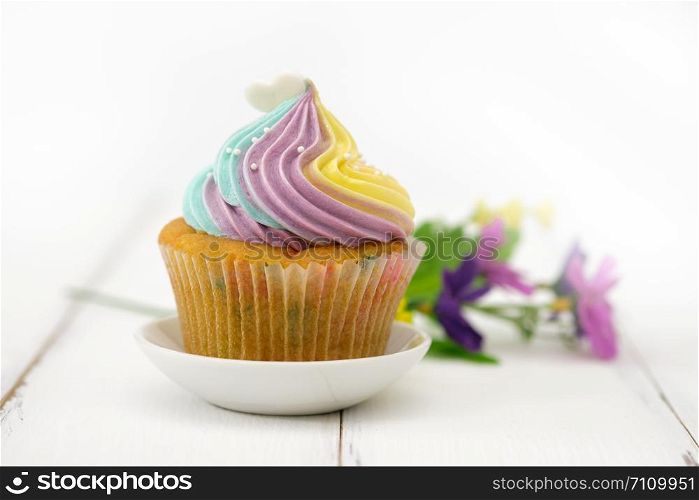Cupcakes are beautifully decorated in clear lighting, AF point selection.